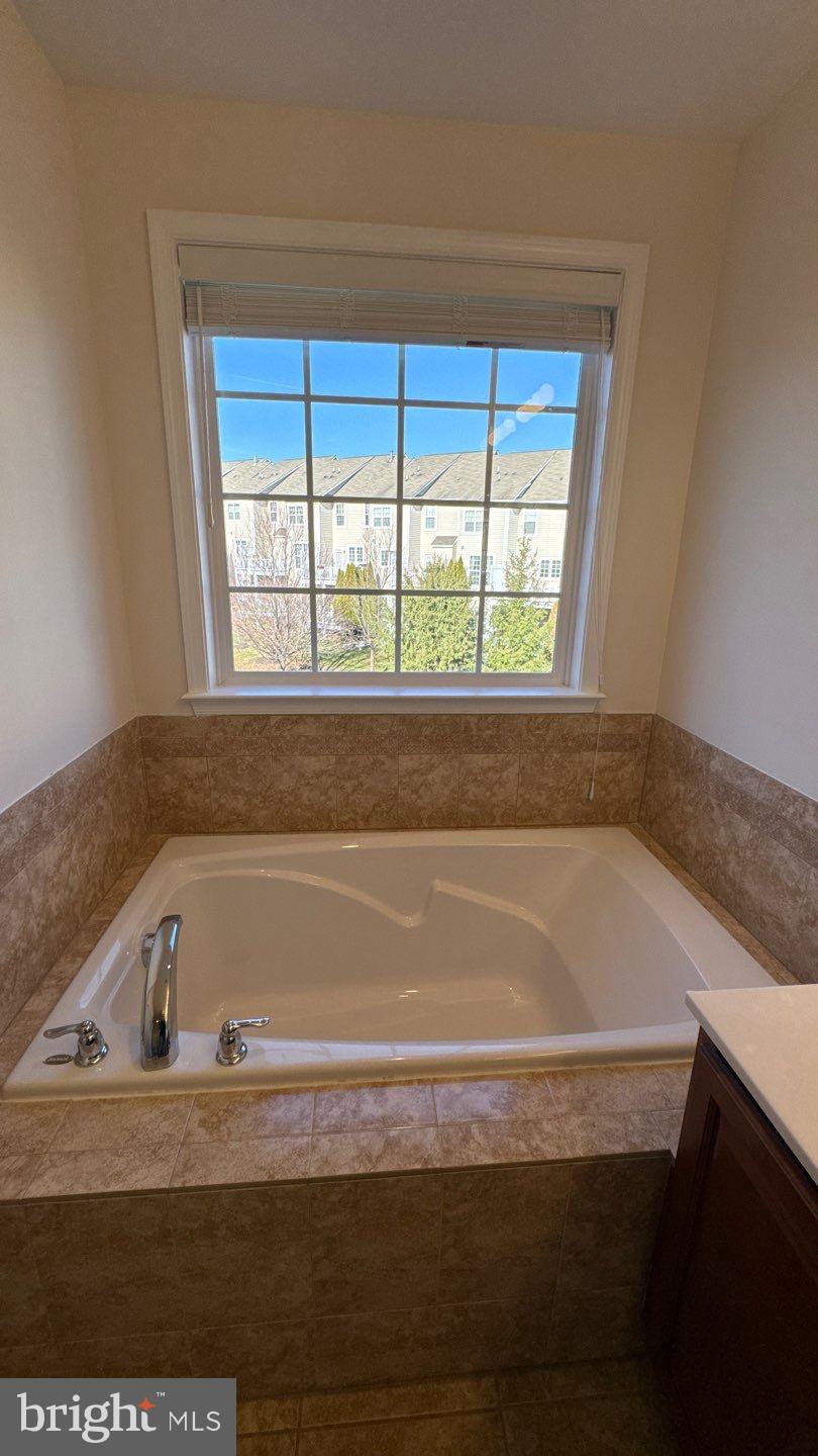 9727 June Flowers Way Laurel, MD 20723 - Photo 18 of 30 a bathroom with a bathtub