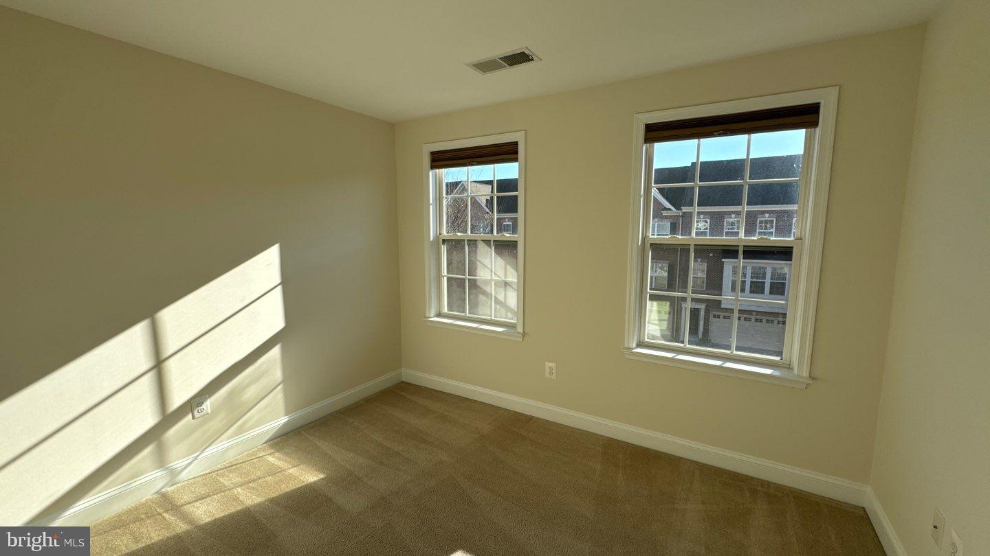 9727 June Flowers Way Laurel, MD 20723 - Photo 24 of 30 a view of an empty room with a window