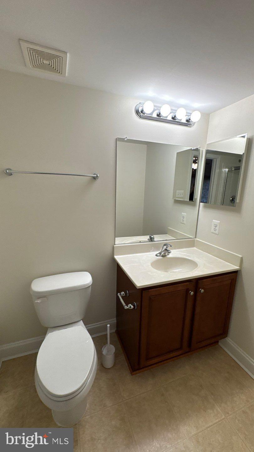 9727 June Flowers Way Laurel, MD 20723 - Photo 28 of 30 a bathroom with a sink and a mirror