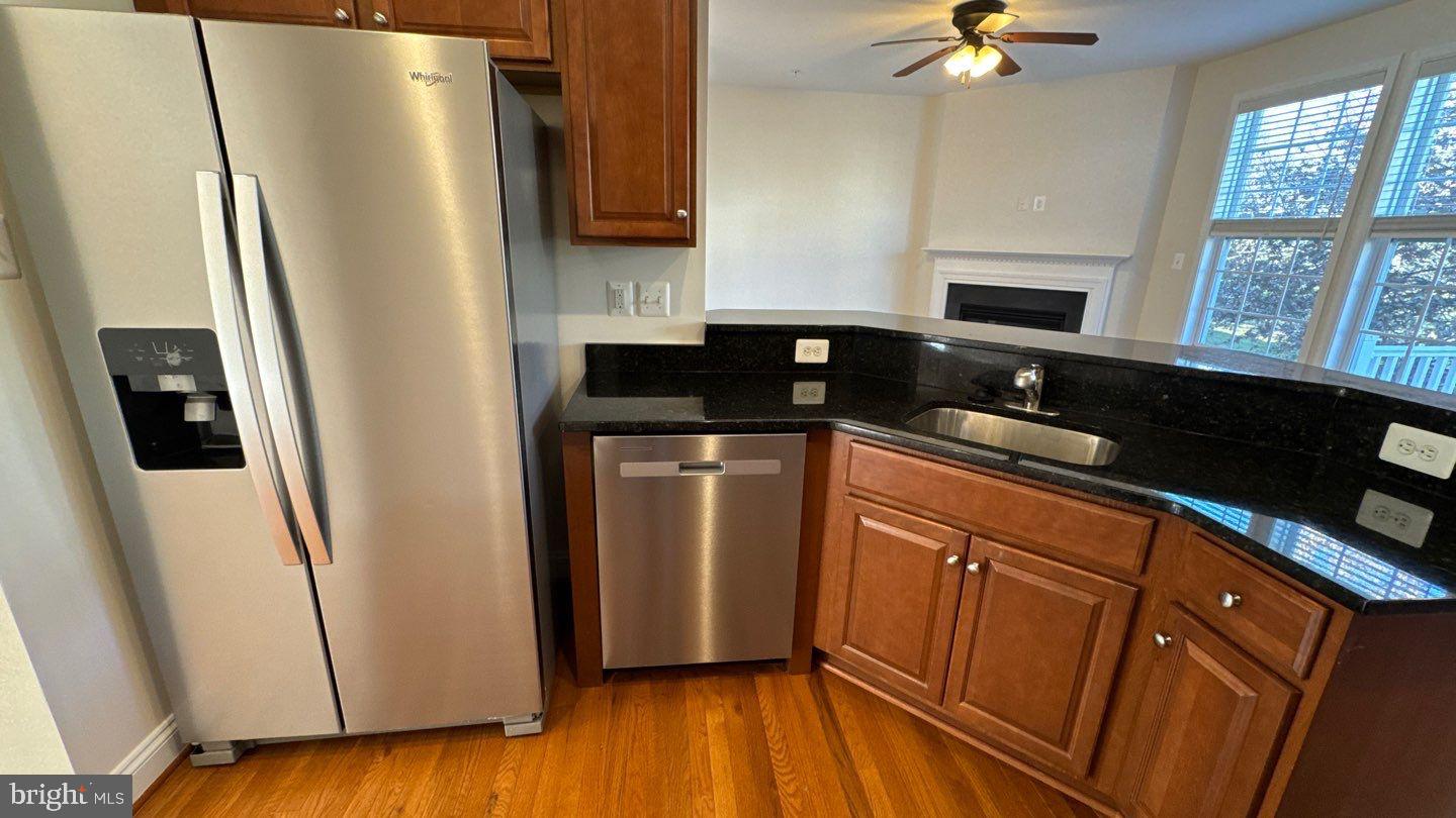 9727 June Flowers Way Laurel, MD 20723 - Photo 9 of 30 a kitchen with stainless steel appliances a refrigerator sink and cabinets