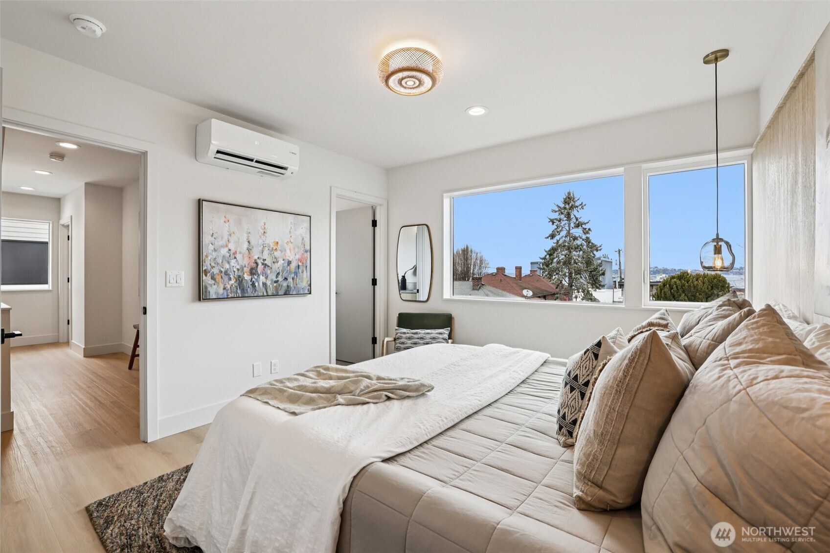 2626 A 58th Avenue Southwest Seattle, WA 98116 - Photo 15 of 40 a bedroom with a large bed and a painting on the wall