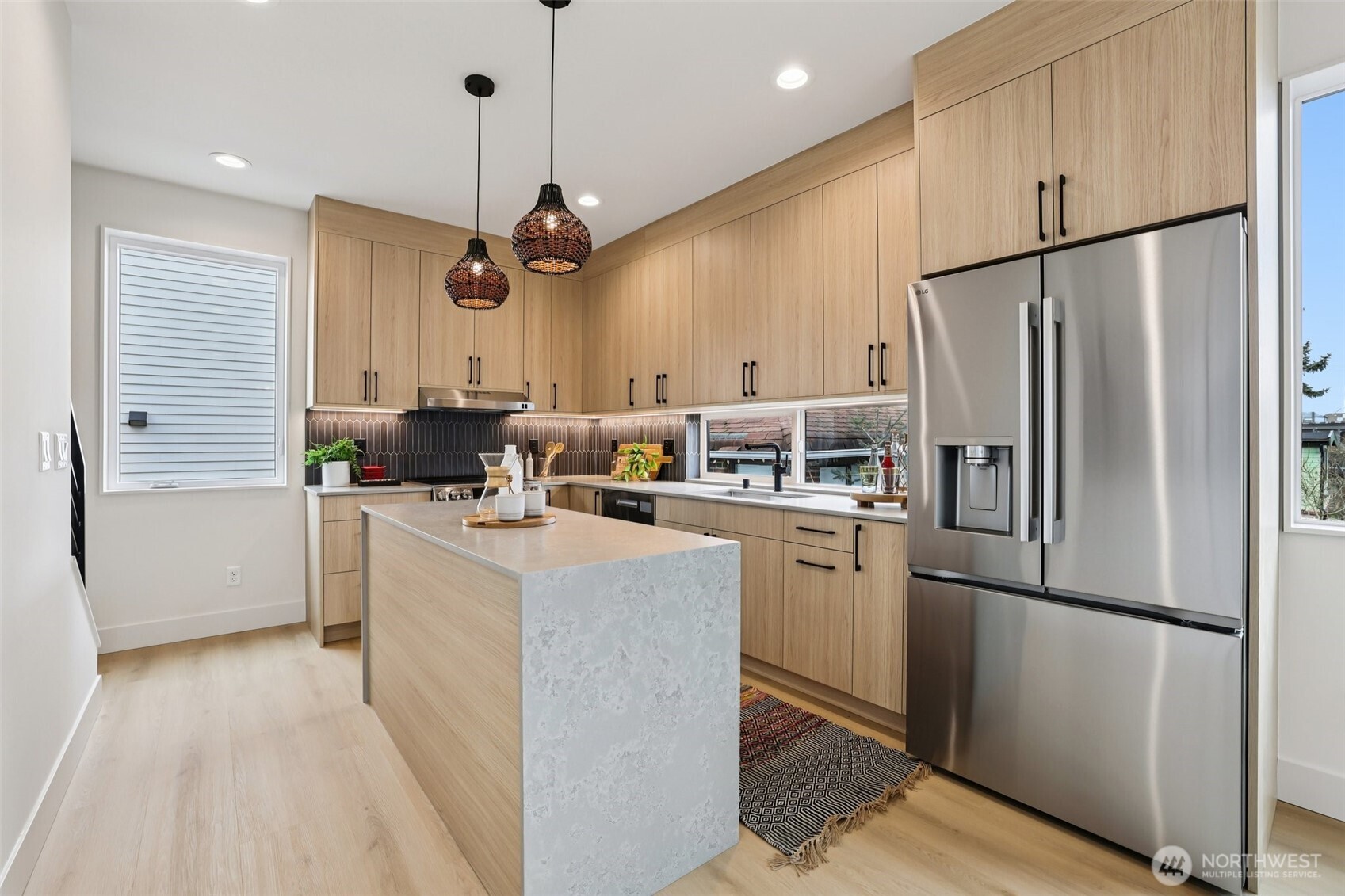 2626 A 58th Avenue Southwest Seattle, WA 98116 - Photo 8 of 40 a kitchen with stainless steel appliances granite countertop a refrigerator a stove a sink and a refrigerator