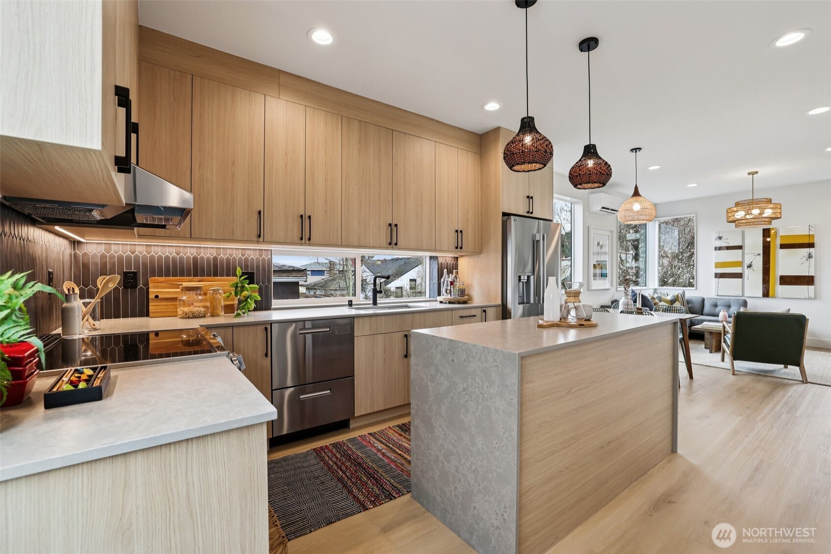 2626 A 58th Avenue Southwest Seattle, WA 98116 - Photo 9 of 40 a kitchen with stainless steel appliances kitchen island granite countertop a sink a stove and a wooden floors