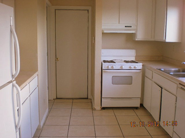 258 Pacifico Place Soledad, CA 93960 - Photo 2 of 12 a kitchen with a stove top oven and cabinets