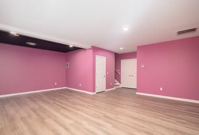 an empty room with a window and a ceiling fan