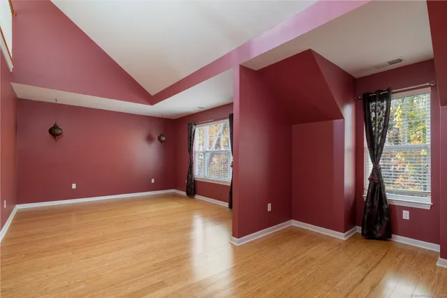 a view of a livingroom with wooden floor and stairs