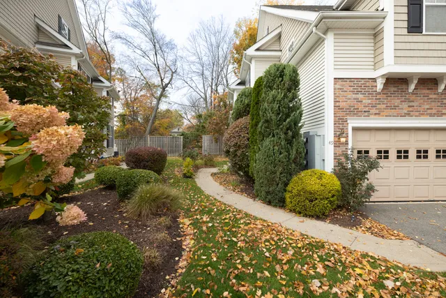 a view of a house with a small yard and a garden