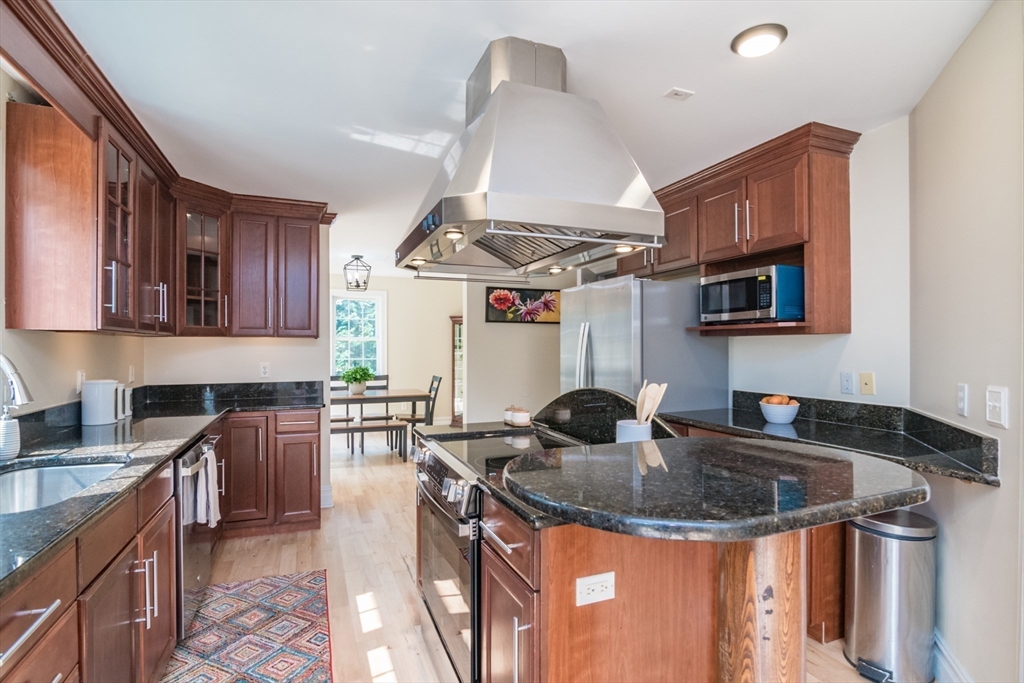 958 East Pleasant Street Amherst, MA 01002 - Photo 12 of 42 a kitchen with stainless steel appliances granite countertop a sink stove and cabinets