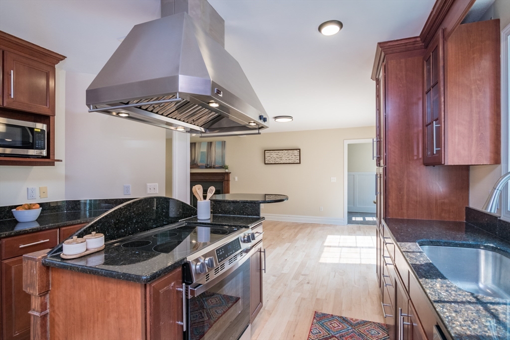 958 East Pleasant Street Amherst, MA 01002 - Photo 14 of 42 a kitchen with granite countertop a stove and a sink