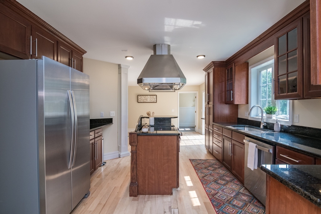 958 East Pleasant Street Amherst, MA 01002 - Photo 15 of 42 a kitchen with stainless steel appliances granite countertop a refrigerator a stove and a wooden floors