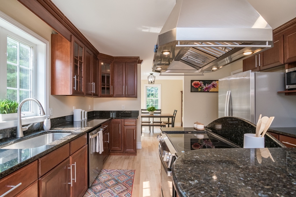 958 East Pleasant Street Amherst, MA 01002 - Photo 16 of 42 a kitchen with granite countertop a sink a stove and cabinets