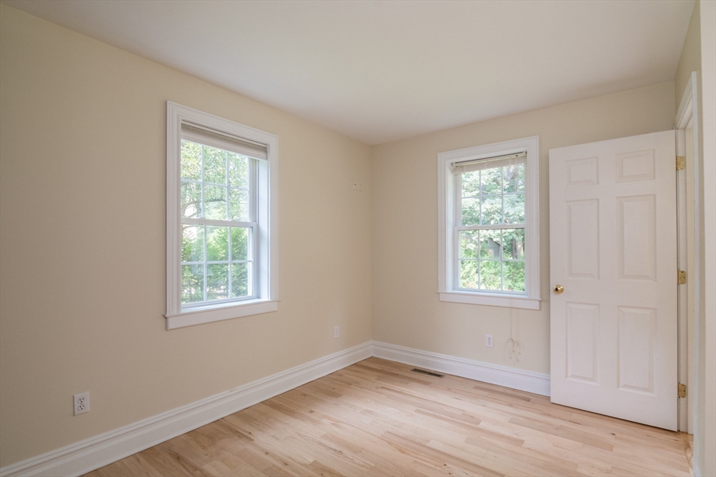 958 East Pleasant Street Amherst, MA 01002 - Photo 20 of 42 an empty room with wooden floor and windows