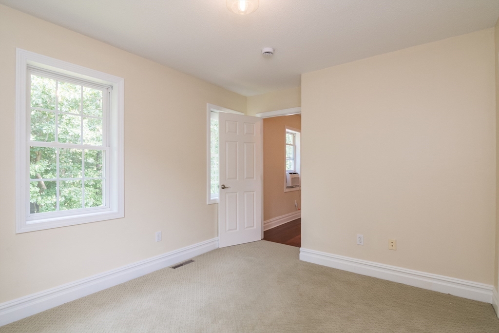 958 East Pleasant Street Amherst, MA 01002 - Photo 32 of 42 an empty room with windows and closet