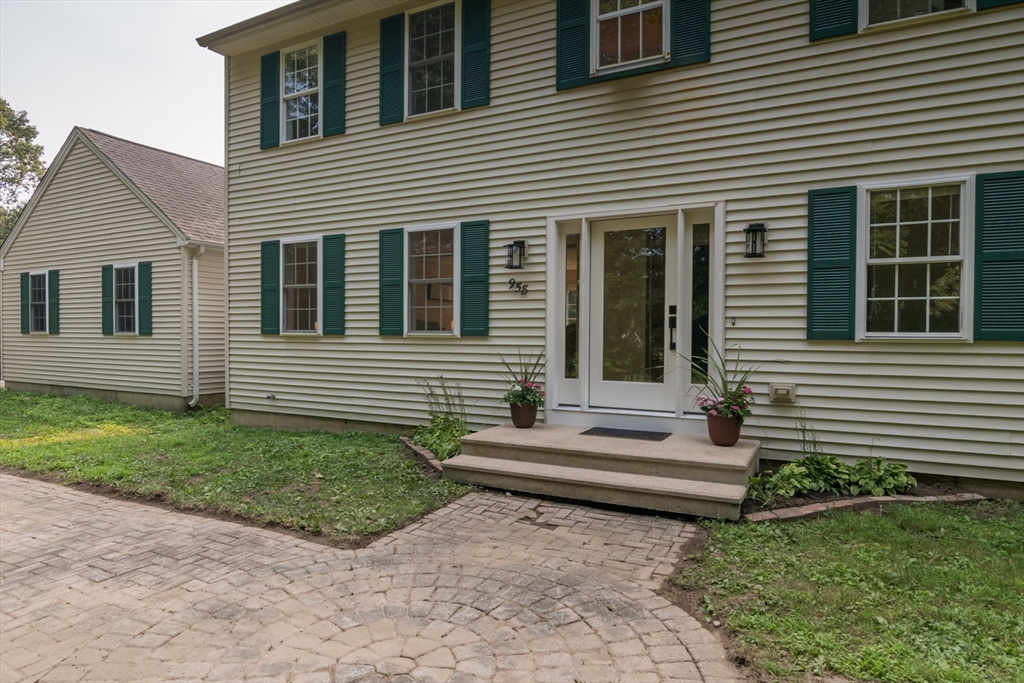 958 East Pleasant Street Amherst, MA 01002 - Photo 4 of 42 a view of a house with a small yard and a large window