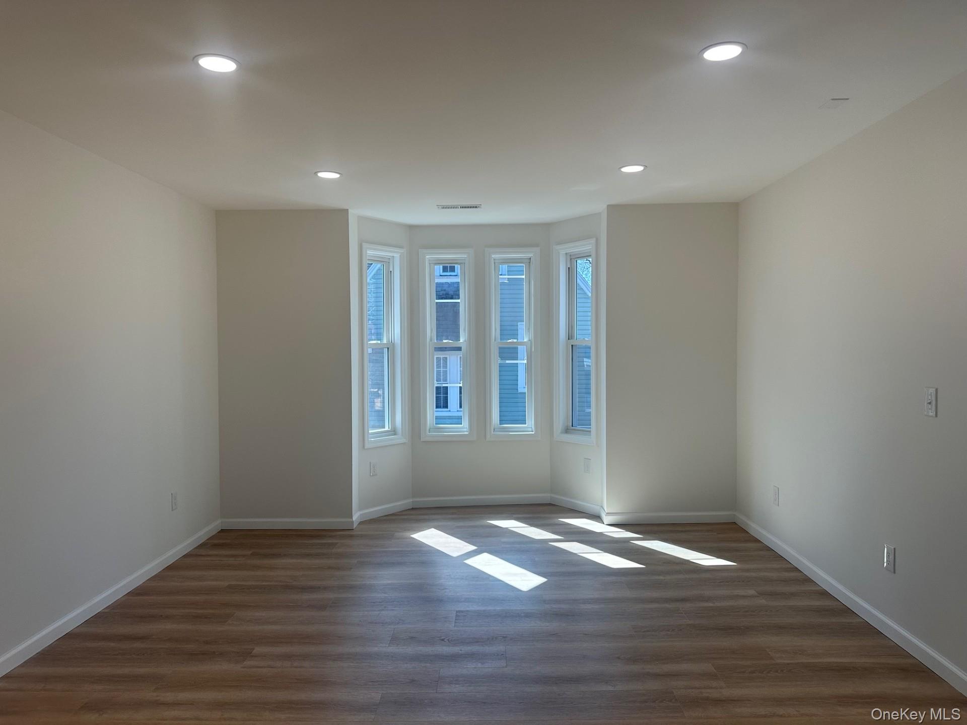 38 Carroll Street, Unit 2 Poughkeepsie, NY 12601 - Photo 4 of 8 a view of empty room with wooden floor and fan