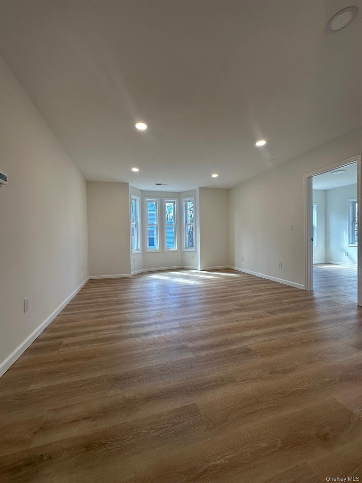 38 Carroll Street, Unit 2 Poughkeepsie, NY 12601 - Photo 5 of 8 a view of empty room with wooden floor and fan