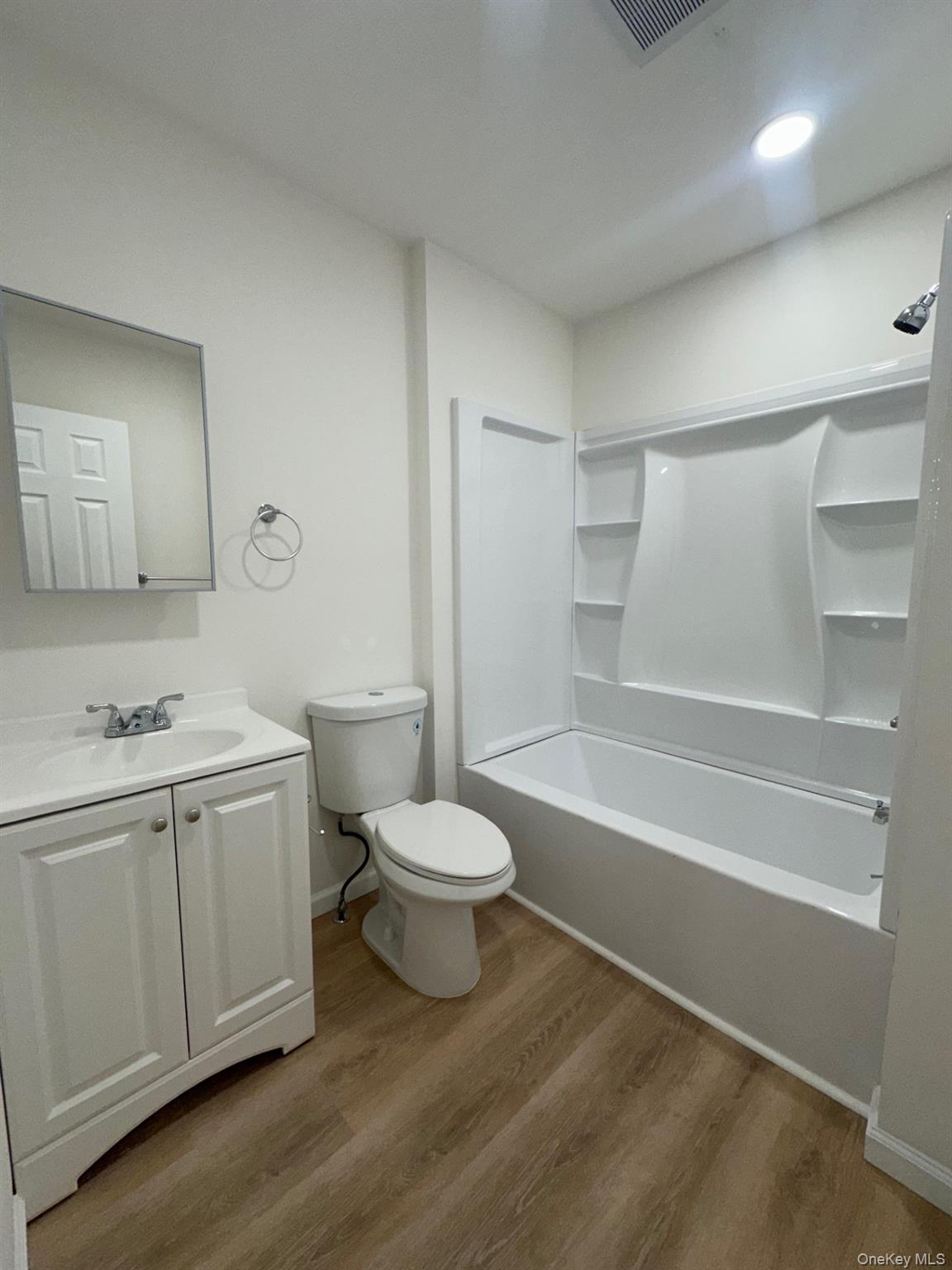 38 Carroll Street, Unit 2 Poughkeepsie, NY 12601 - Photo 6 of 8 a bathroom with a toilet a sink and bathtub