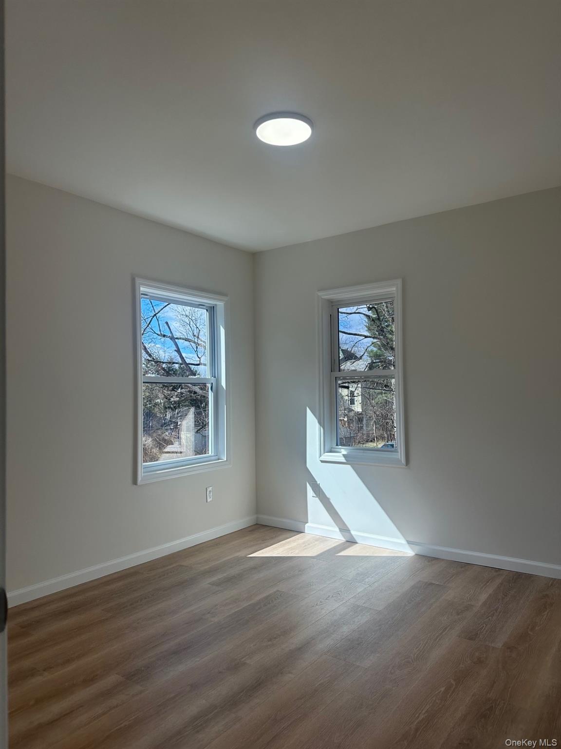38 Carroll Street, Unit 2 Poughkeepsie, NY 12601 - Photo 8 of 8 a view of a livingroom with wooden floor and a window