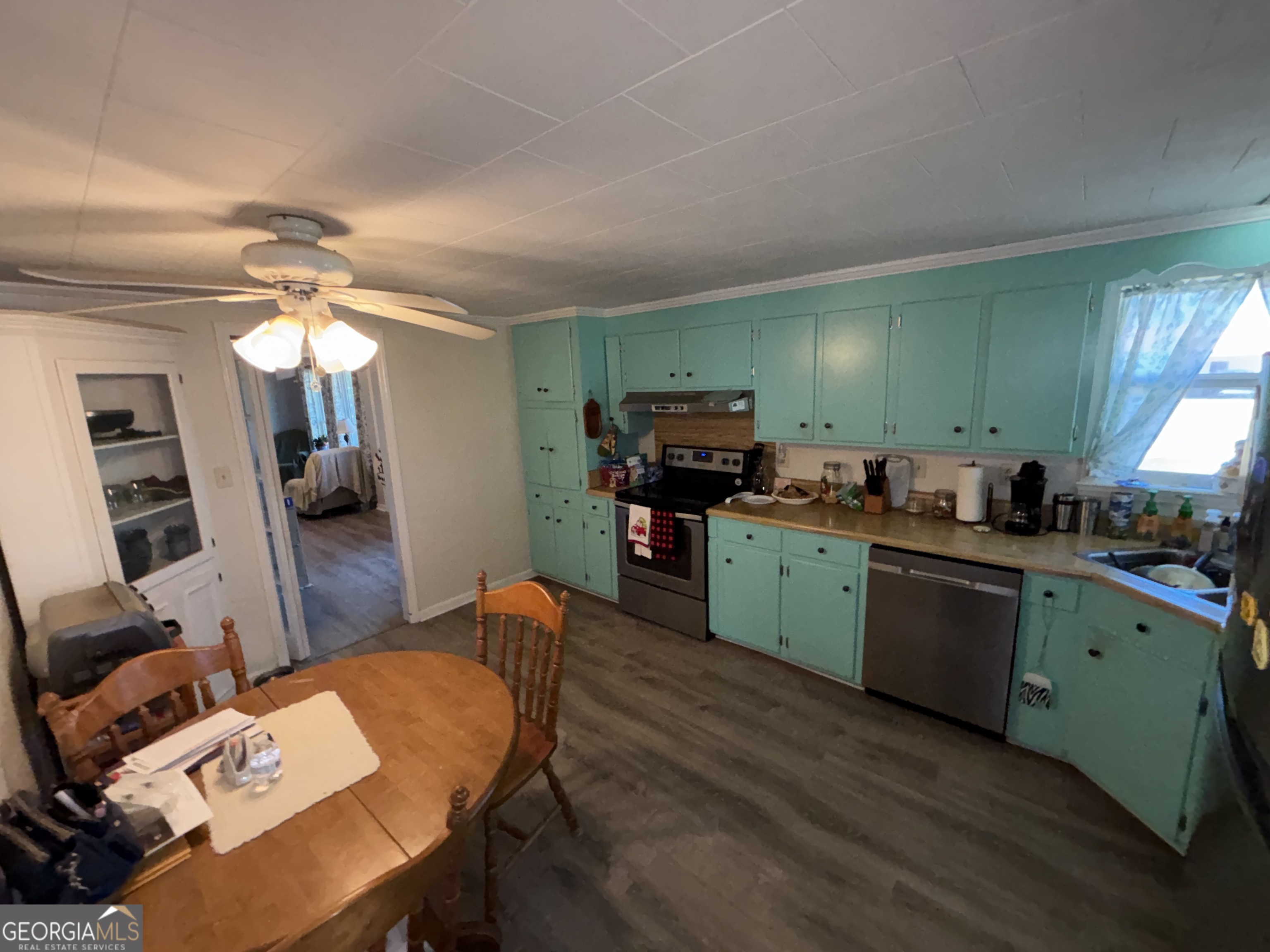 216 East Peter Street Cochran, GA 31014 - Photo 14 of 44 a kitchen with cabinets a counter space and a fireplace