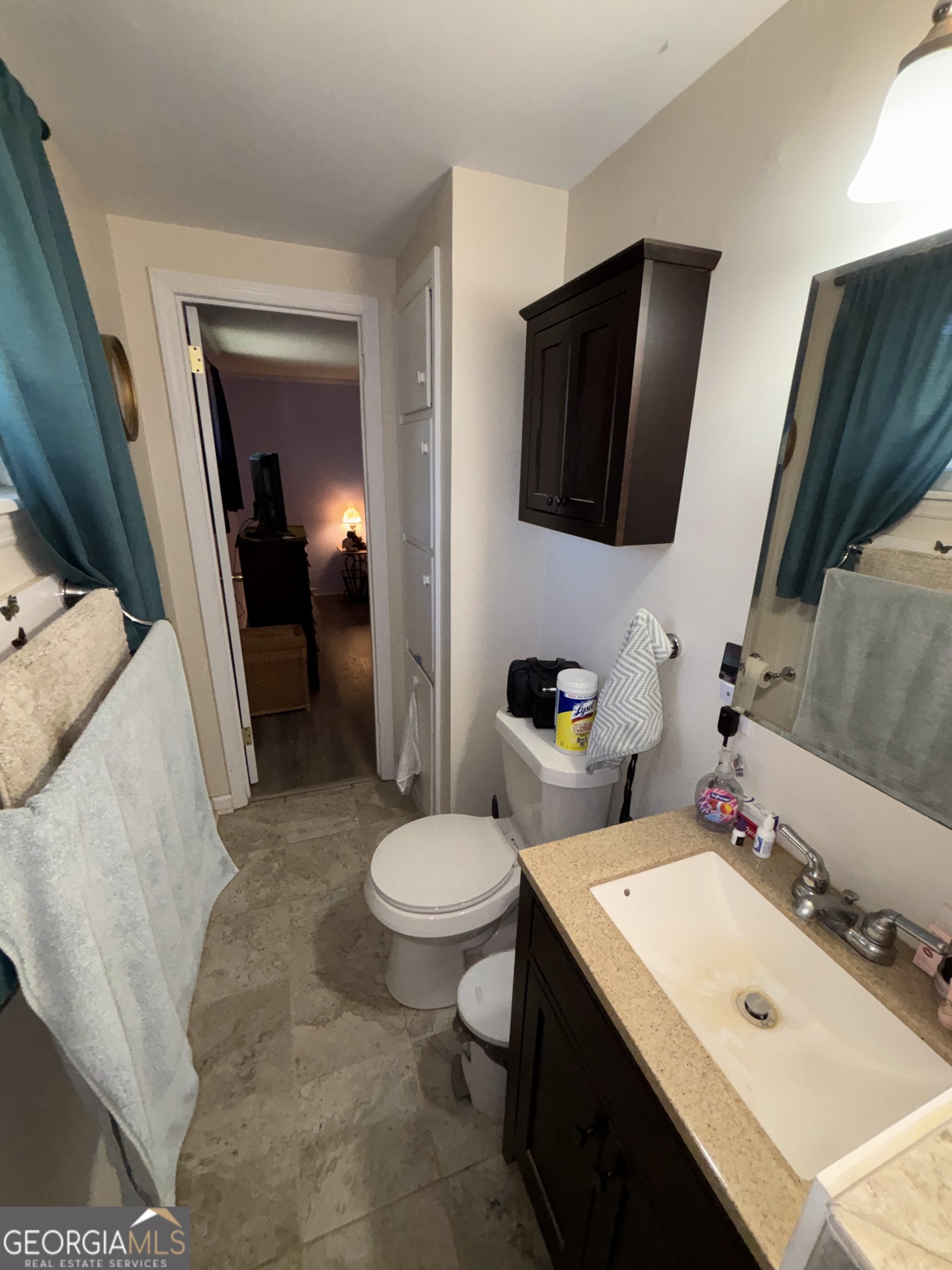 216 East Peter Street Cochran, GA 31014 - Photo 27 of 44 a bathroom with a sink toilet and mirror