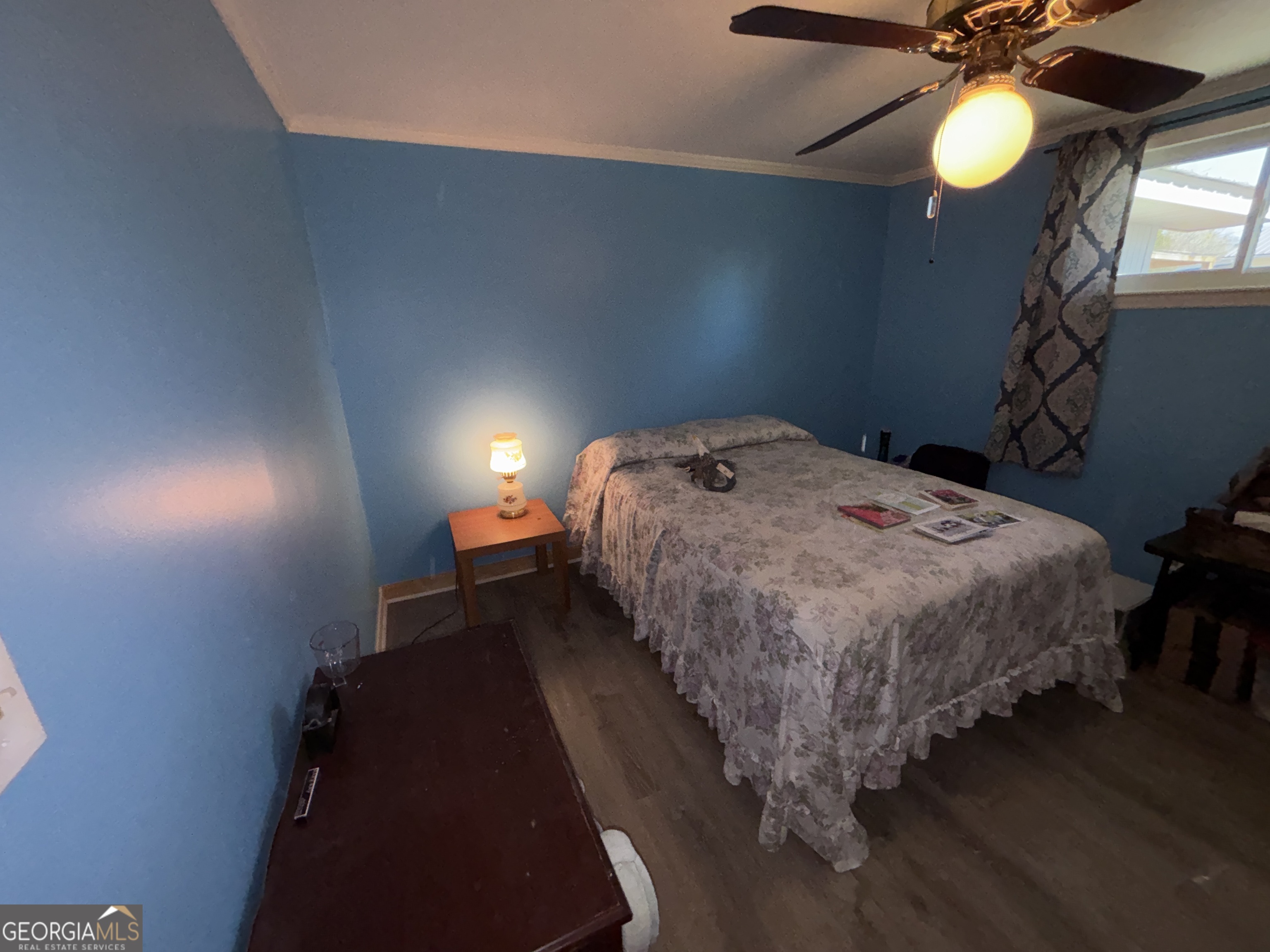 216 East Peter Street Cochran, GA 31014 - Photo 28 of 44 a bed sitting in a bedroom next to a lamp