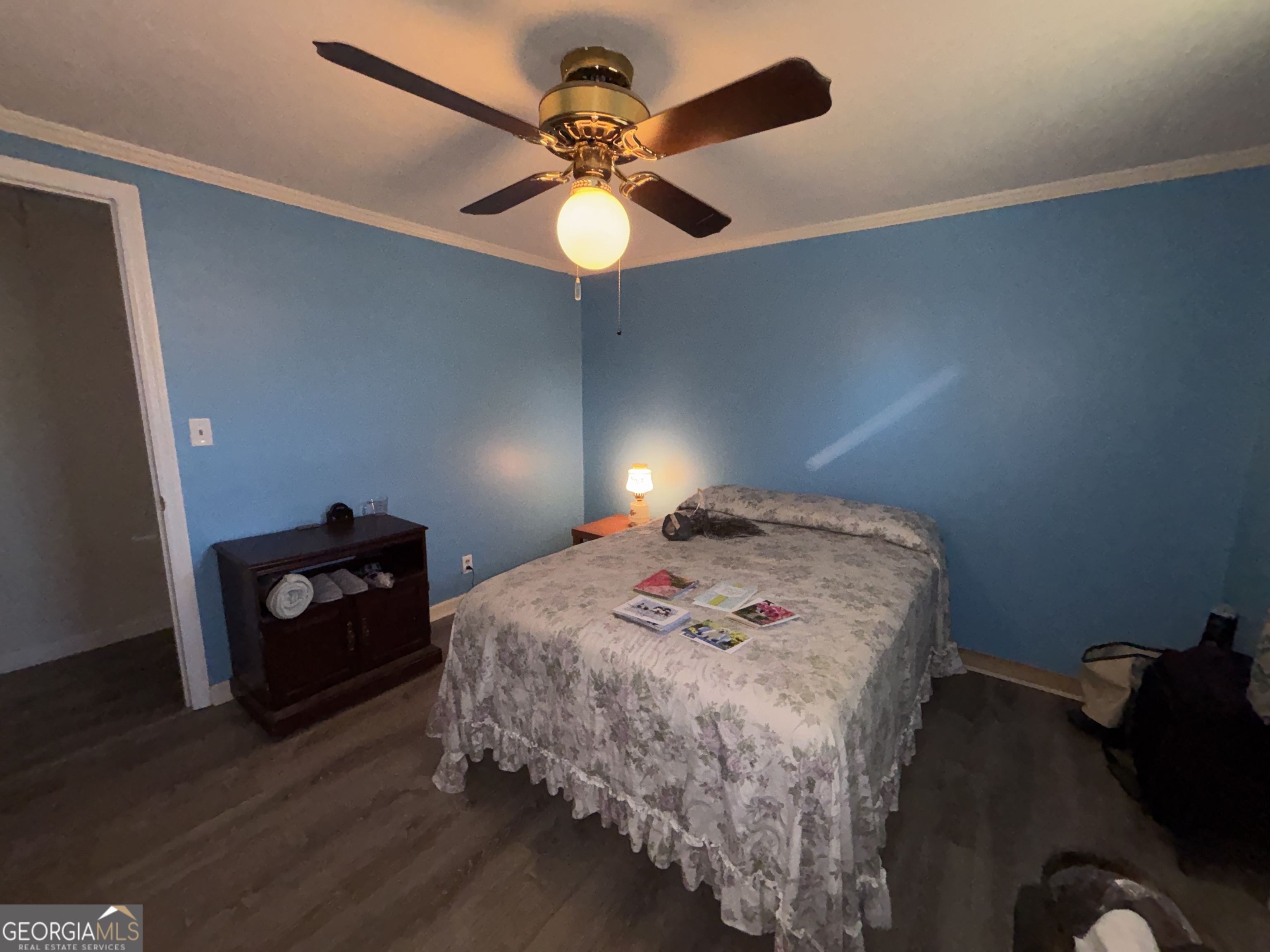 216 East Peter Street Cochran, GA 31014 - Photo 29 of 44 a bedroom with a bed and a chandelier