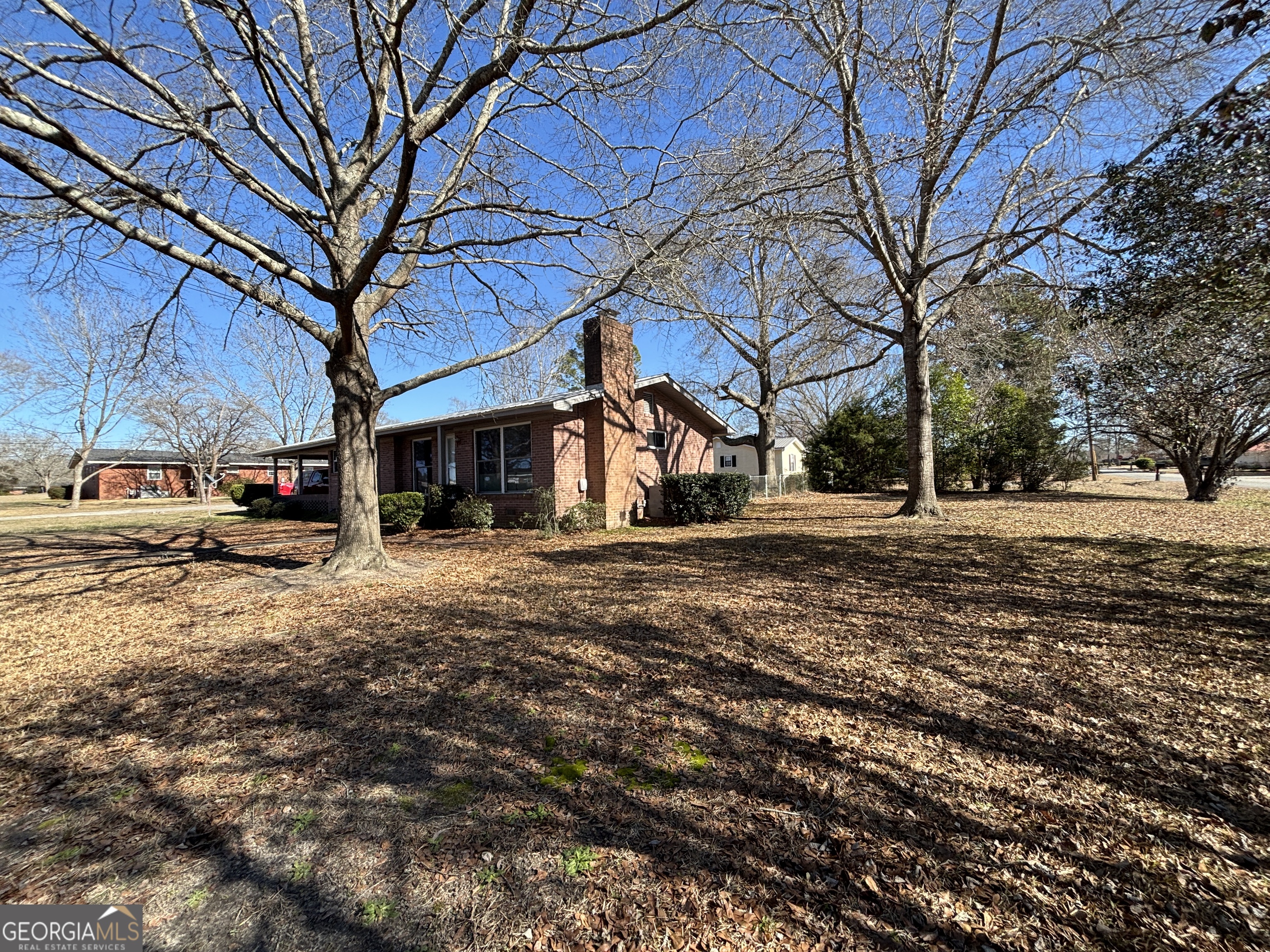 216 East Peter Street Cochran, GA 31014 - Photo 3 of 44 a front view of a building with a yard
