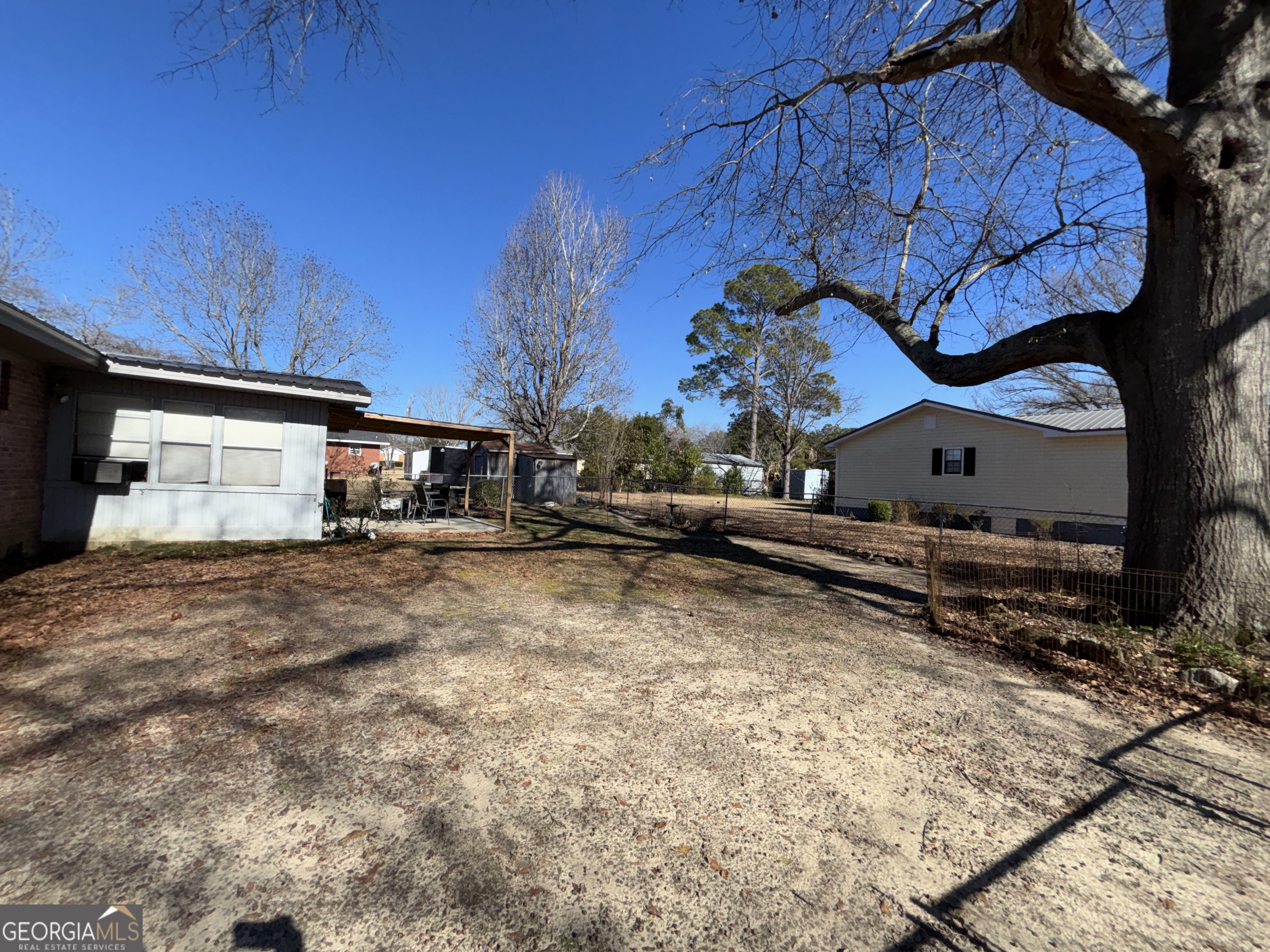 216 East Peter Street Cochran, GA 31014 - Photo 38 of 44 a view of a house with a yard and sitting area