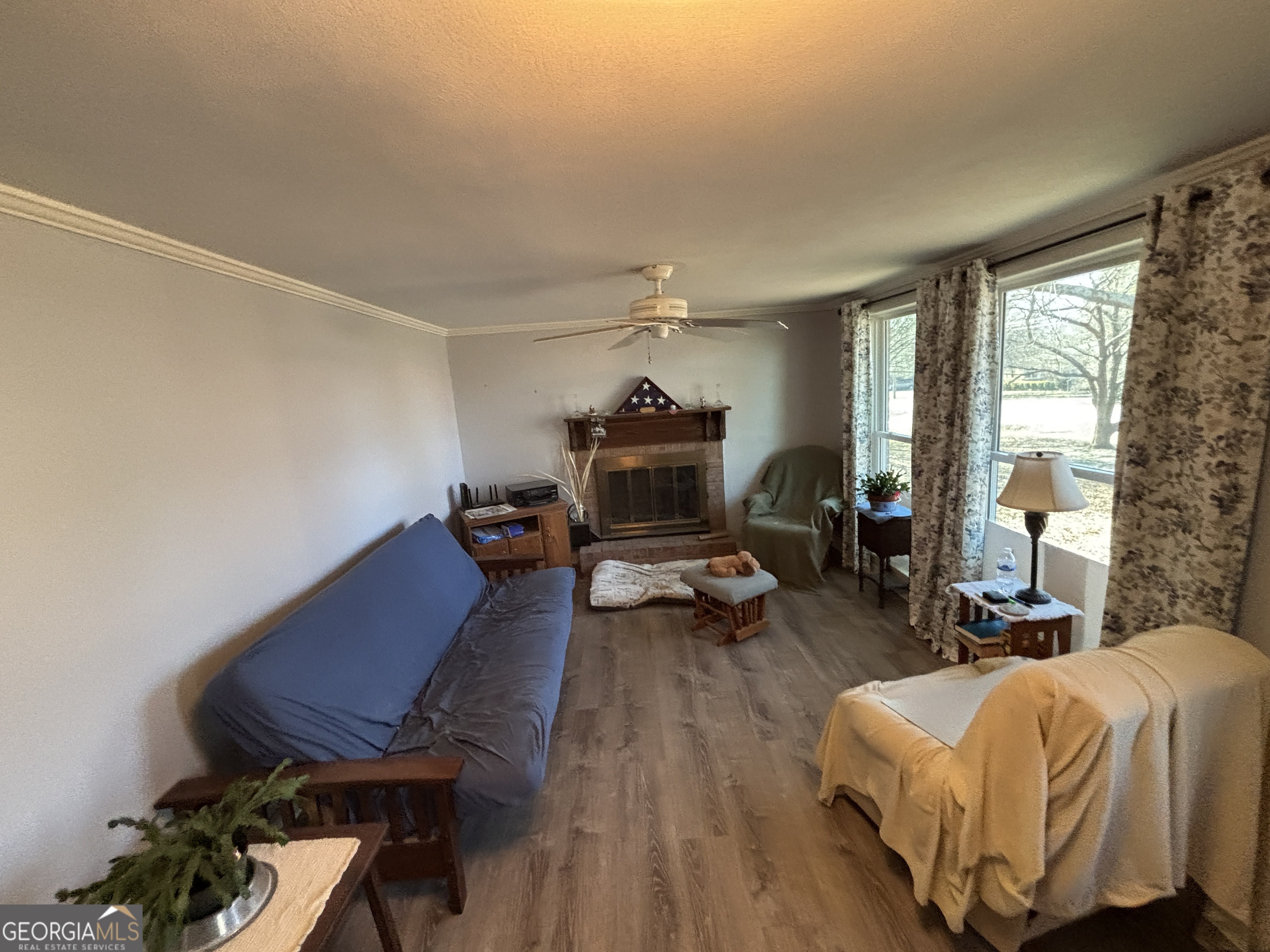 216 East Peter Street Cochran, GA 31014 - Photo 8 of 44 a living room with furniture and a fireplace
