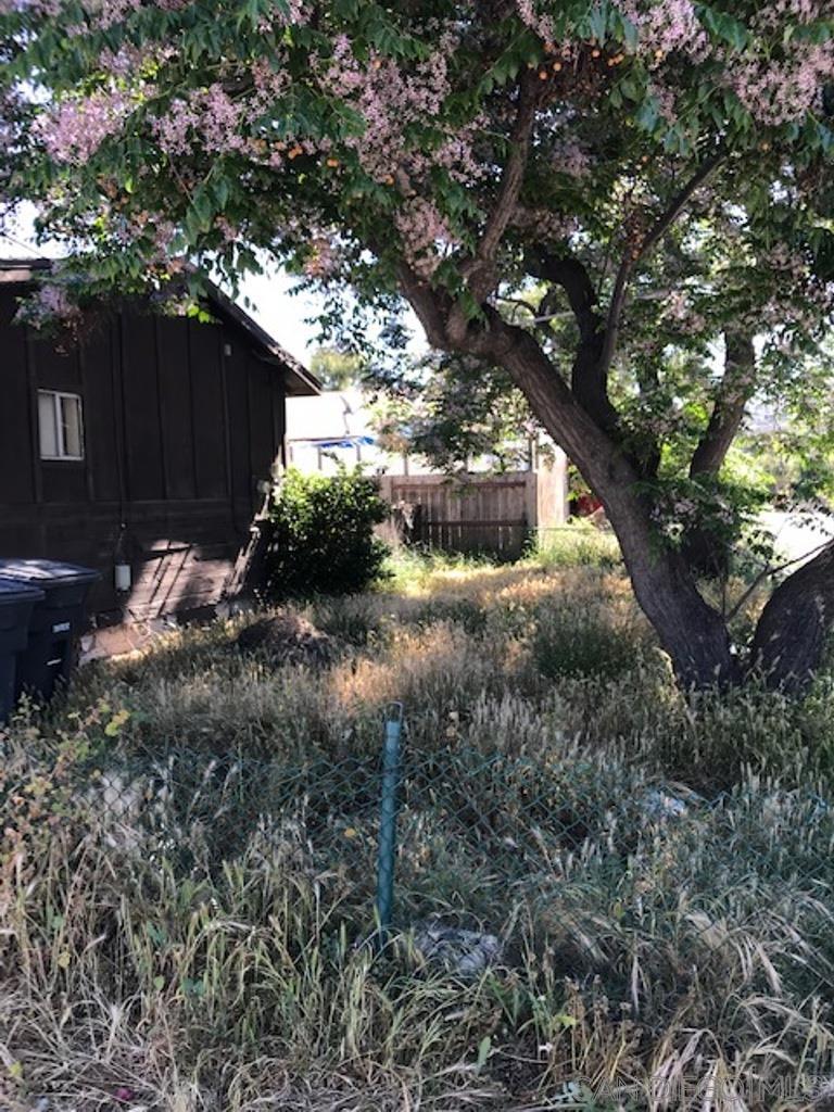 8654 Tyler Street Spring Valley, CA 91977 - Photo 5 of 9 a backyard of a house with a yard and outdoor seating
