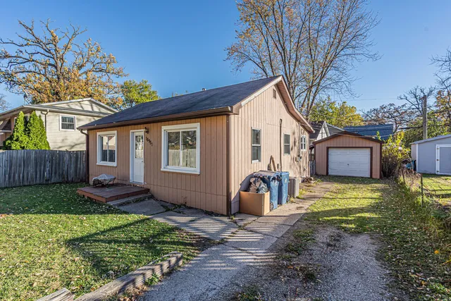 a view of a house with backyard and a tree
