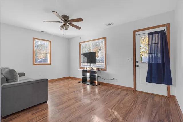 a living room with hardwood floor and a window