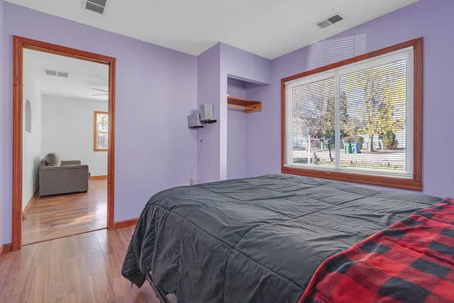 a bedroom with a bed and a large window