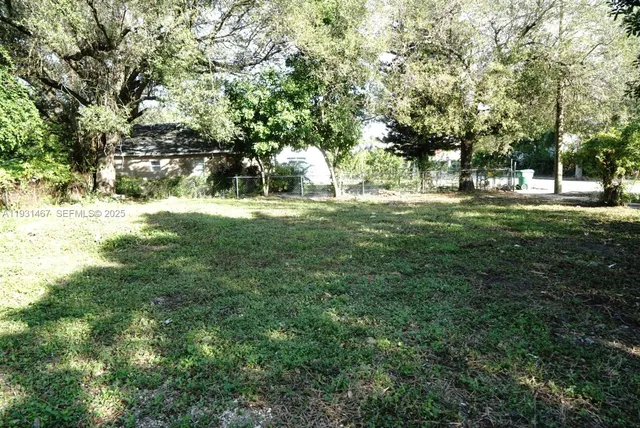 a view of a yard with trees