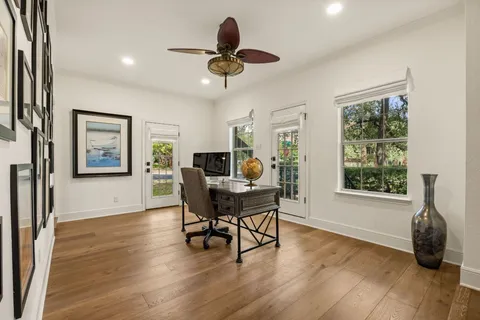 a workspace with wooden floor and windows