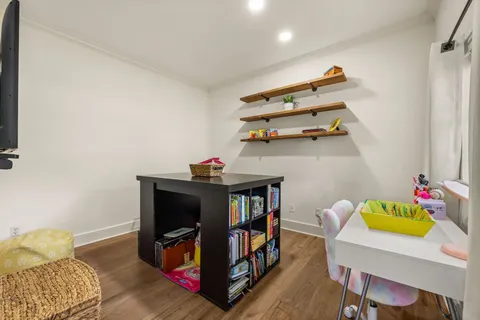 a bedroom with furniture and a wooden floor