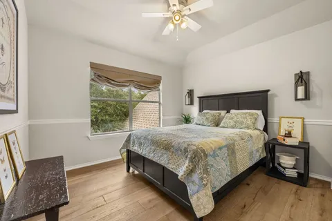 a bed sitting in a bedroom next to a window