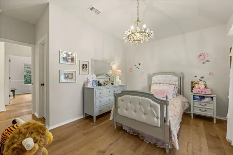 a bedroom with a bed and a chandelier