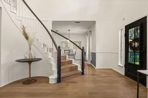 a view of entryway with wooden floor and stairs