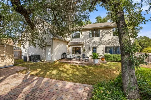 a view of a house with backyard sitting area and garden
