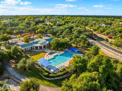 an aerial view of residential houses with swimming pool and outdoor space