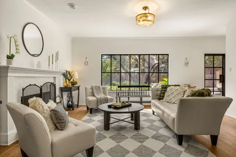 a living room with furniture a rug and a window