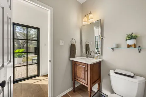 a bathroom with a toilet a sink and a mirror
