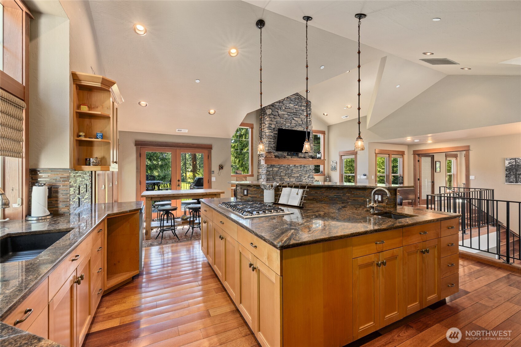 110 Larkspur Loop Cle Elum, WA 98922 - Photo 14 of 40 a kitchen with stainless steel appliances granite countertop a sink a stove and a wooden floor
