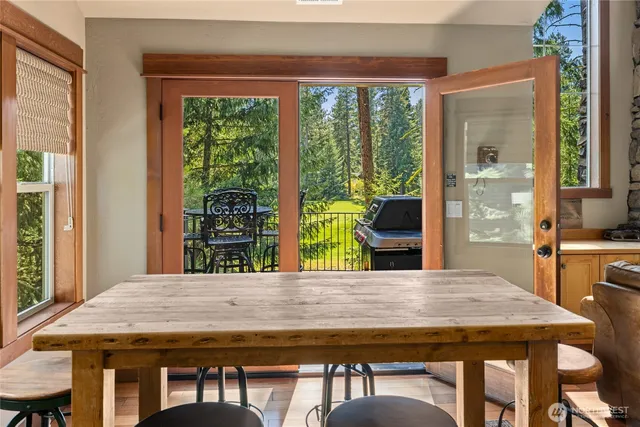 a dining table with chairs and window