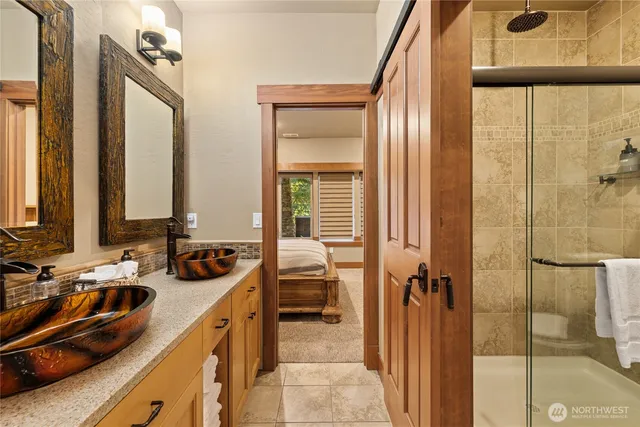 a bathroom with a sink a toilet and a mirror