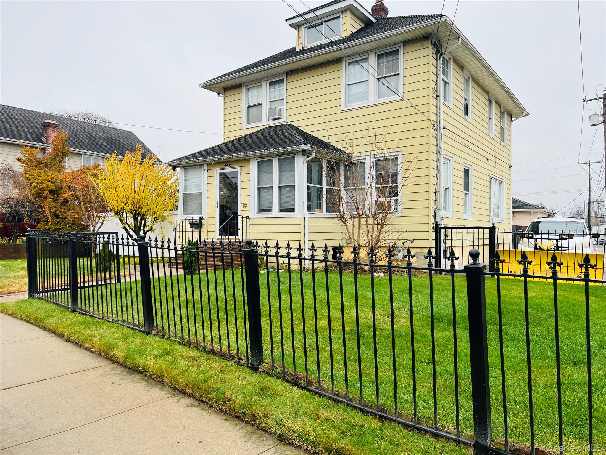 83 Roger Avenue Inwood, NY 11096 - Photo 1 of 6 a front view of a house with a garden