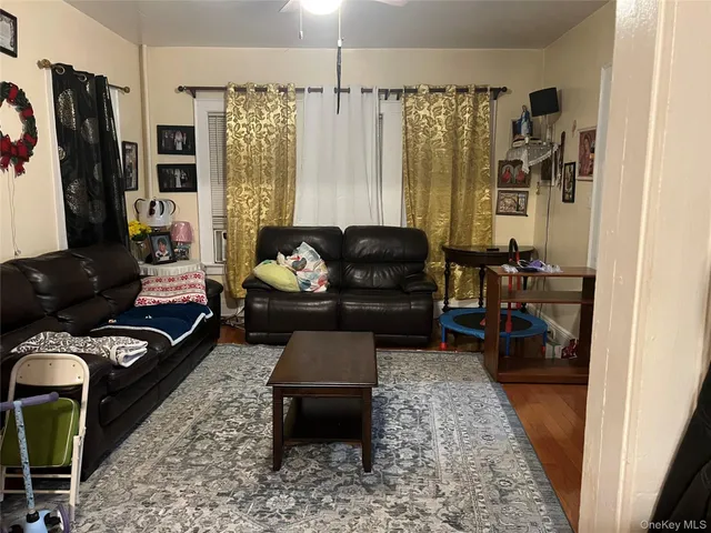 a living room with furniture fireplace and a window