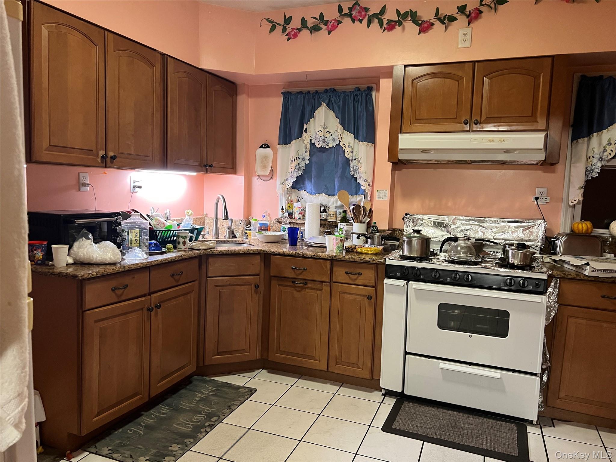 83 Roger Avenue Inwood, NY 11096 - Photo 3 of 6 a kitchen with stainless steel appliances granite countertop a stove a sink and a microwave