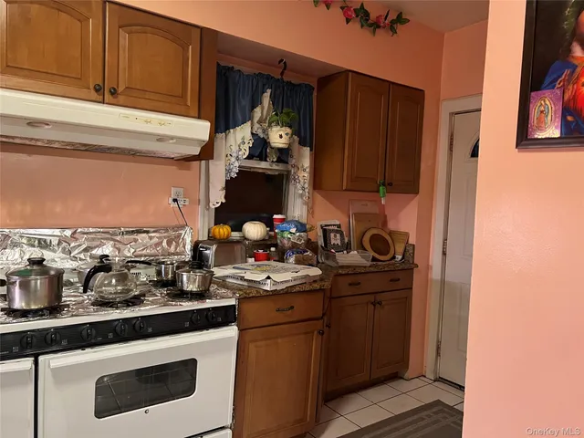 a kitchen with a stove and a refrigerator